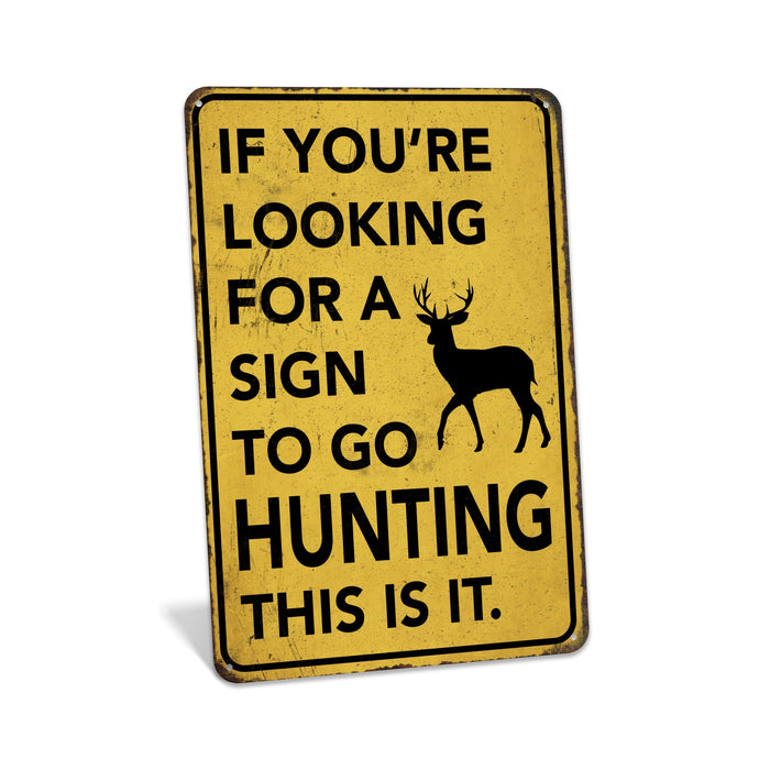 Rustic yellow metal hunting sign reading If You're Looking for a Sign to Go Hunting This Is It with deer silhouette