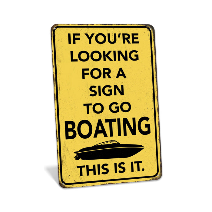 Rustic yellow metal boating sign reading If You're Looking for a Sign to Go Boating This Is It with speedboat silhouette