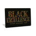 Rustic metal sign displaying the words “Black Excellence” in bold typography, designed as inspirational cultural wall décor.