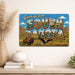 Greetings from South Dakota metal sign with horizontal vintage 'Greetings from South Dakota' large-letter postcard with